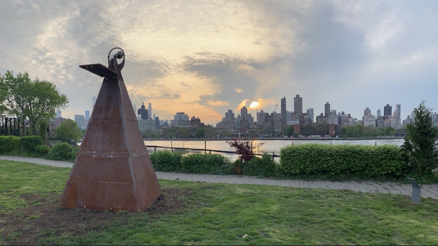 Photo of Beatriz Cortez's installation showing a teepee at a park with the New York City skyline in the distance