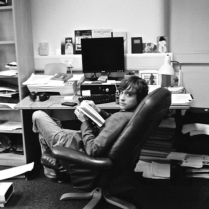 Photo of John Donaldson sitting at his desk