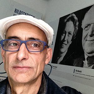 Selfie photo of Pino Trogu in front of posters