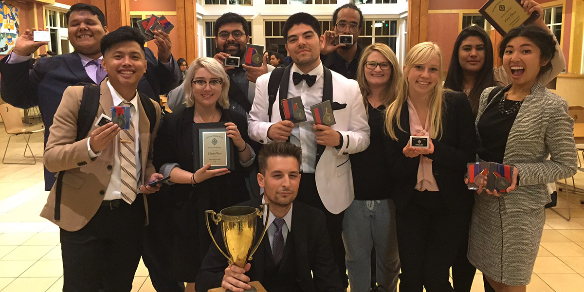 Photo of Forensics Team holding their trophies