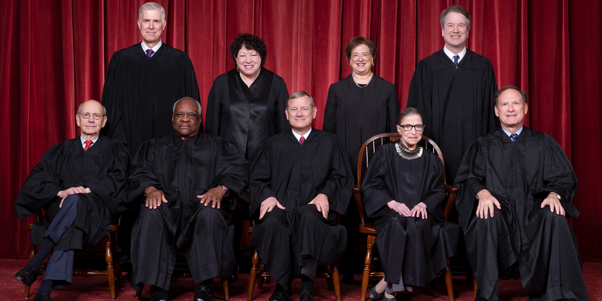 Photo of all nine Supreme Court justices in front of a dark red curtain