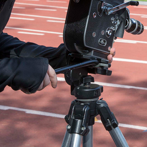 Photo of student shooting analog film on track at Cox Stadium