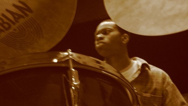Sepia-tone photo of Afro-Cuban Jazz Ensemble drummer