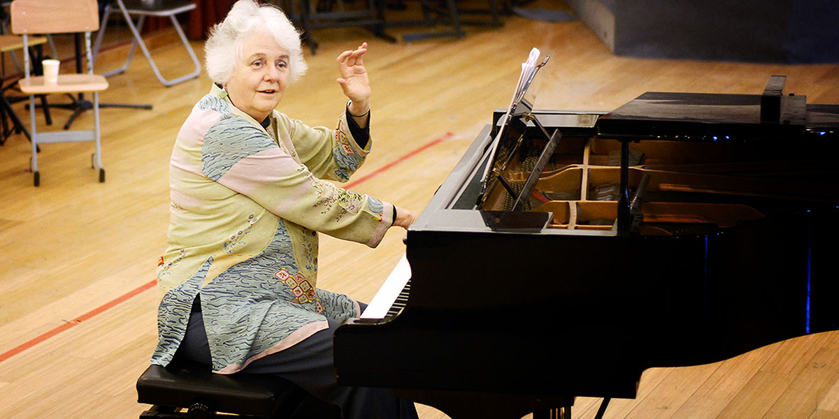 Photo of Elinor Armer playing piano
