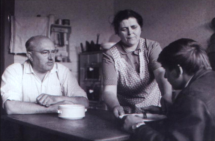 Still from Black Peter of three people talking at a table