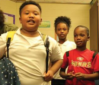 Still of three children from Outspoken Truth documentary