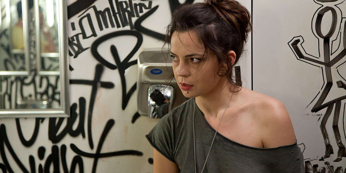 Photo of actress Maria Dinulescu in graffiti-filled restroom from the film Double