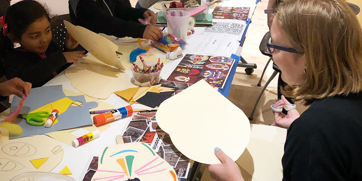 Photo of families working on arts and crafts at Global Museum