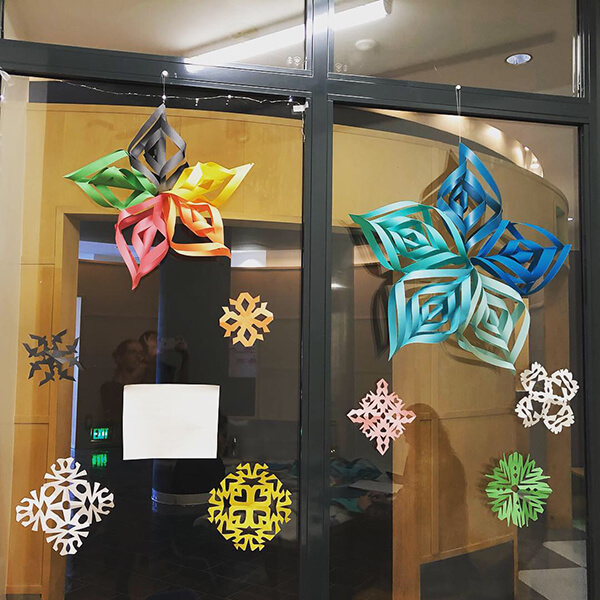 Photo of Global Museum window decorated with paper stars and snowflakes
