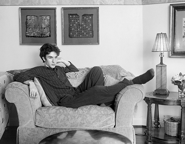 Photo of teenager sitting on couch