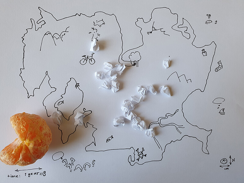 A drawing of map and an orange