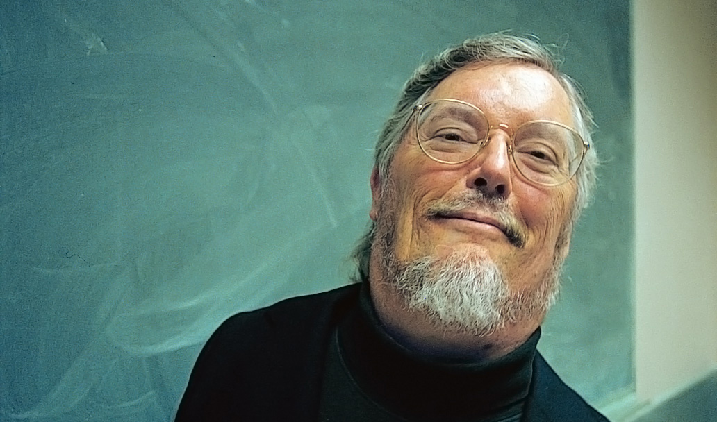 Photo of Paul K. Longmore in front of chalkboard