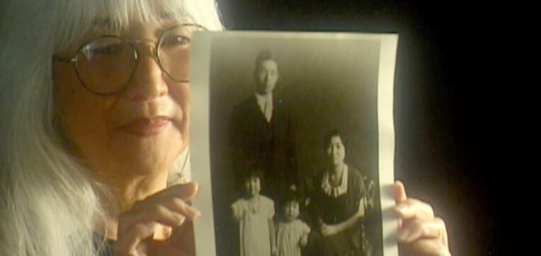 Emiko Omori holds an old family photo