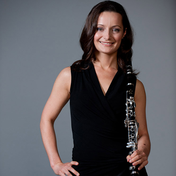 Photo of Mara Plotkin holding a clarinet in her left hand