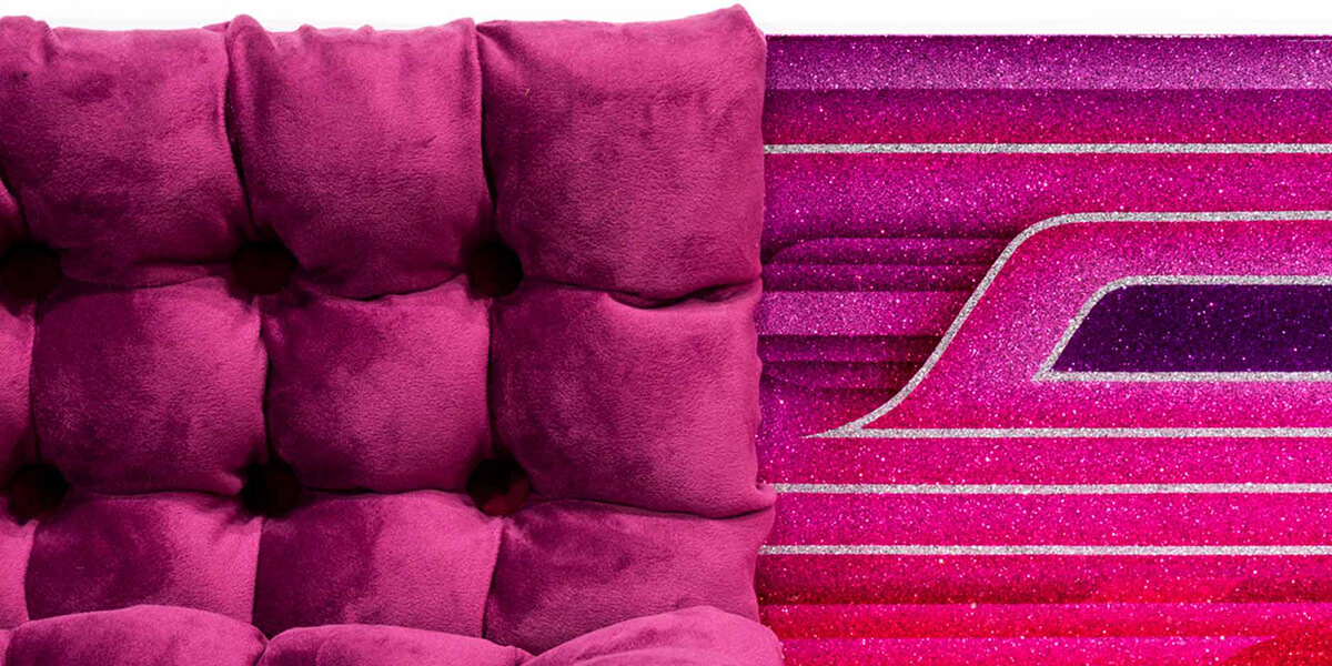 Photo of a velvet loveseat and a glittery velvet- and purple-colored graphic