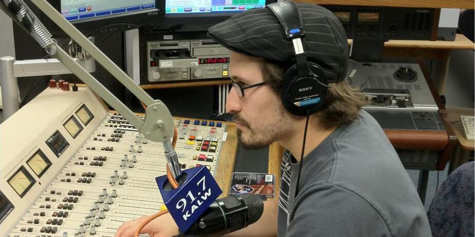 Photo of Devon Strolovich working on KALW-FM's radio control board