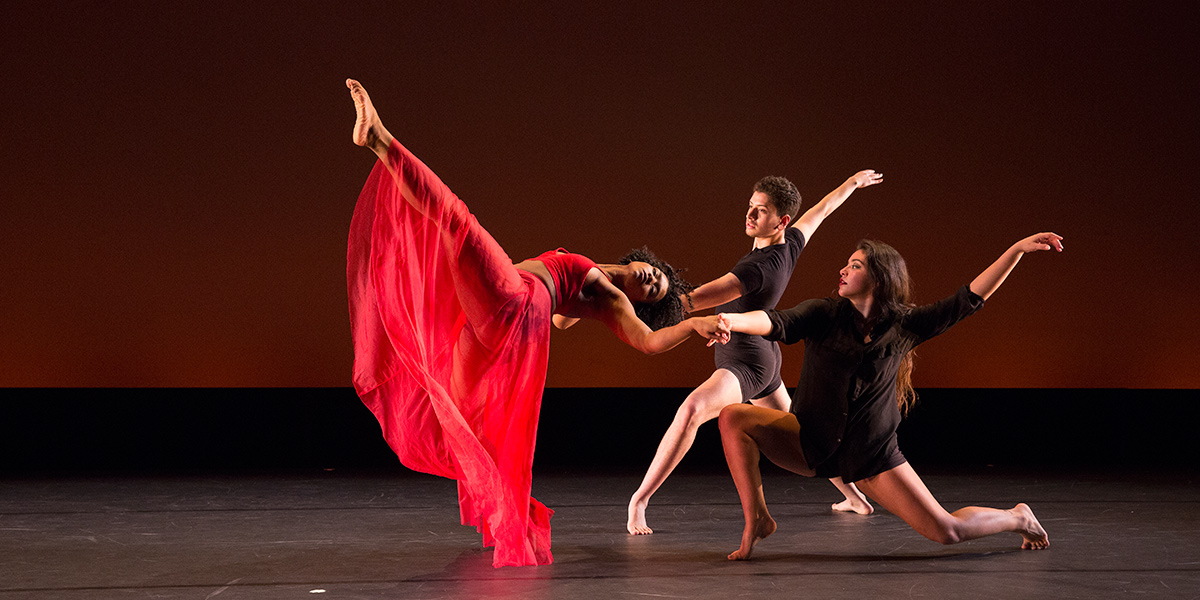 Photo of three student dancers performing