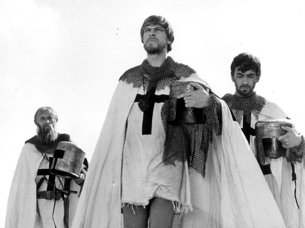 Black and white photo of three knights walking