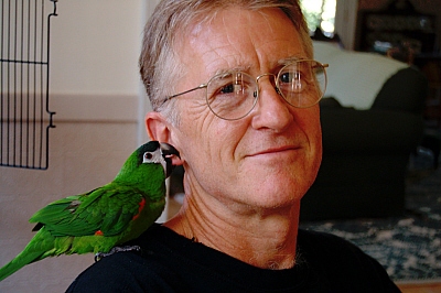 Photo of Curtis White with a parrot on his shoulder