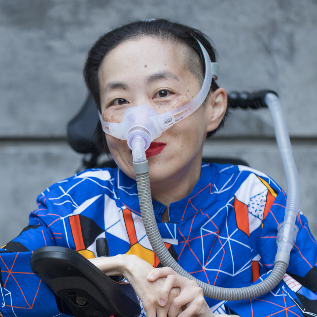 Photo of Alice Wong in a power chair