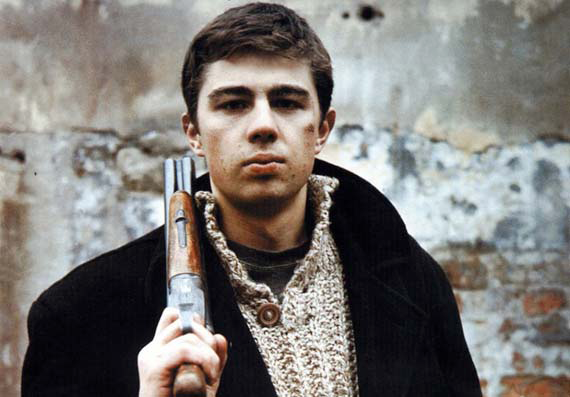 Photo of young man holding rifle on his shoulder