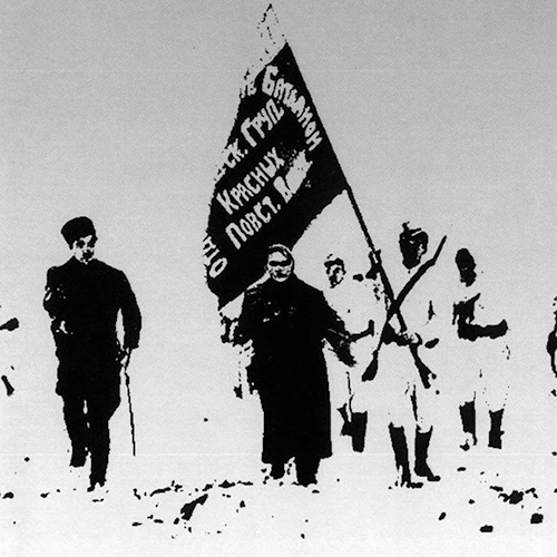 Black and white photo of people walking, holding flag
