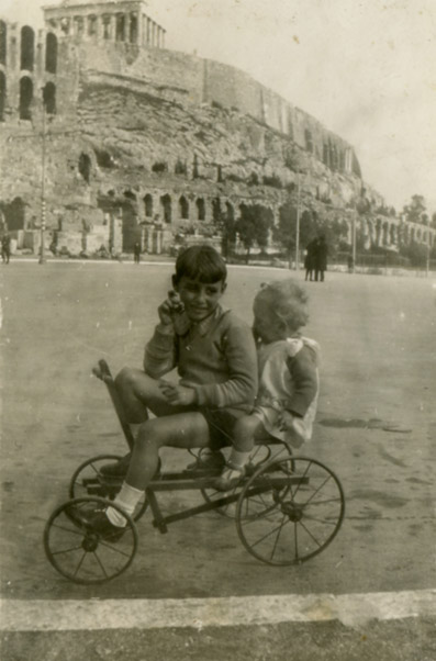 Photo of two children riding a cycle