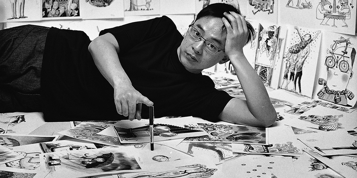 Photo of Jimmy Liao laying down surrounded by illustrations