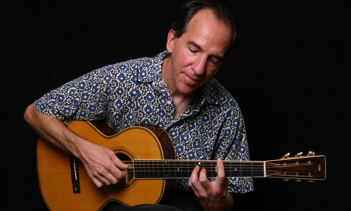 Photo of Alan Perlman playing guitar