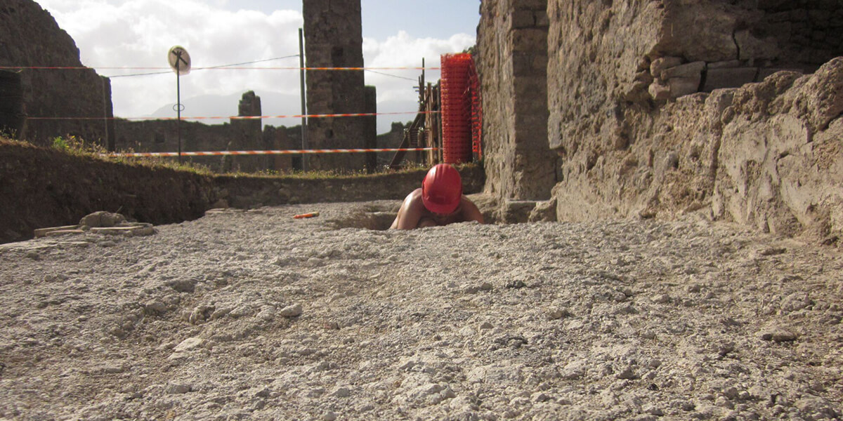 Photo of person digging at excavation site