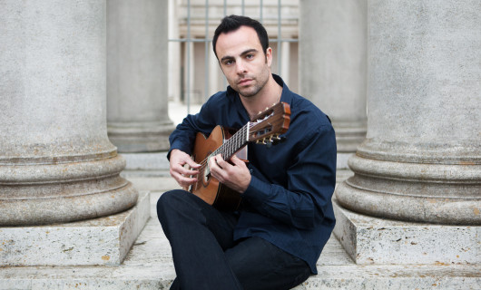 Photo of Paul Psarras playing classical guitar