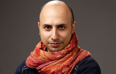 Photo of Hamid Rahmanian wearing a red and orange scarf