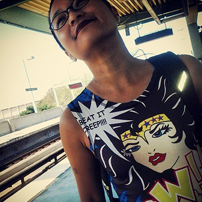 Photo of Barbara Jane Reyes standing on a platform at a train station