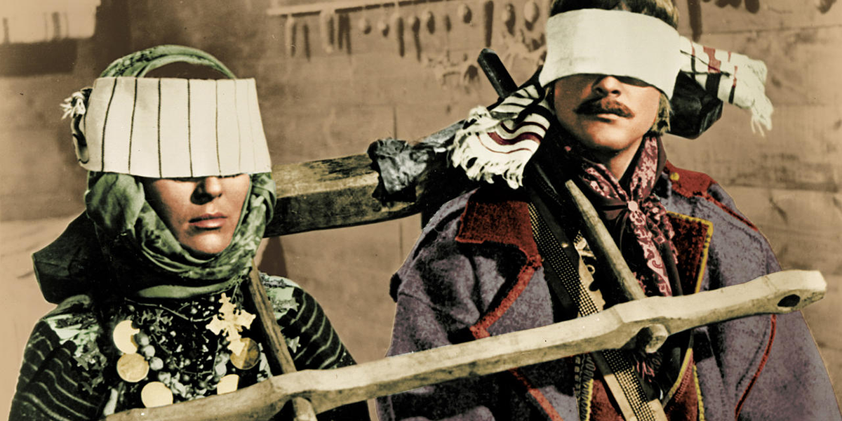 Photo of man and woman wearing masks covering their eyes