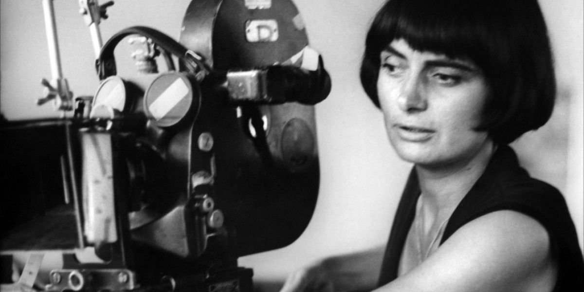 Black and white photo of Agnes Varda working with film camera