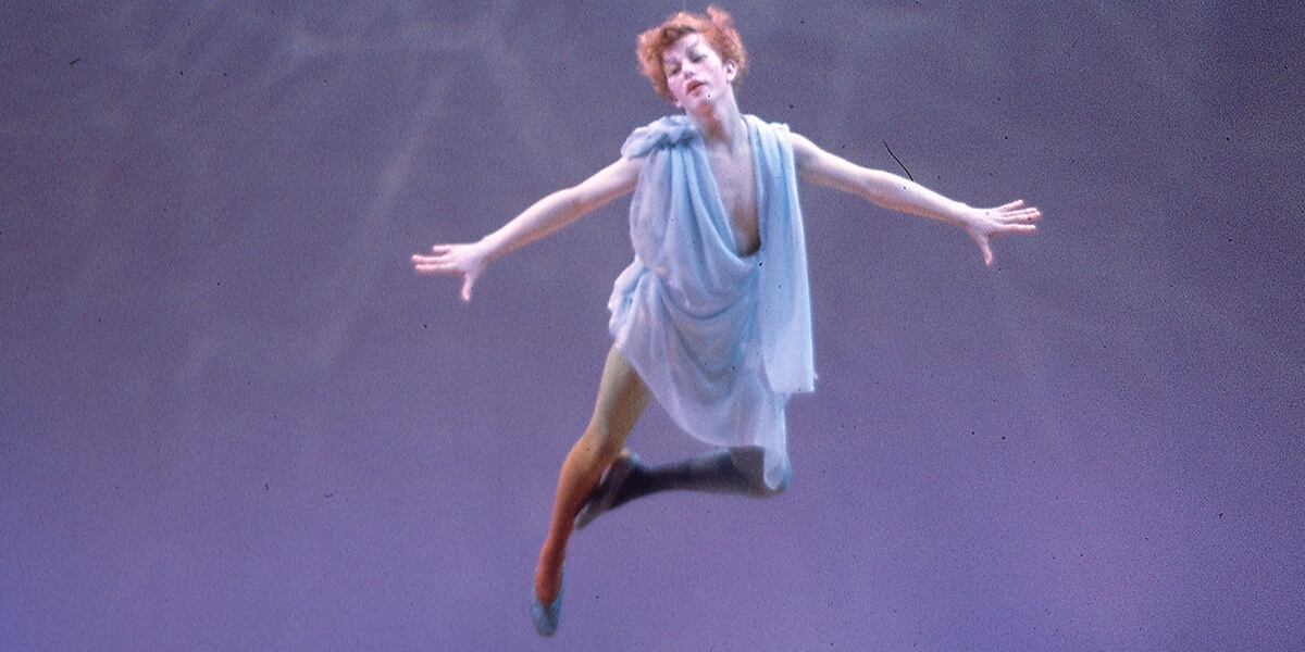 Photo of Roy Loney flying on stage in his role as Ariel in The Tempest at SF State in 1964