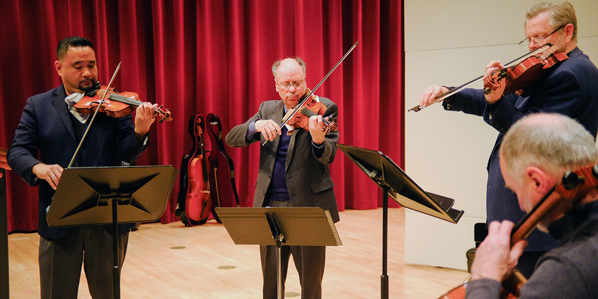 Photo of the Alexander String Quartet in rehearsal in Knuth Hall