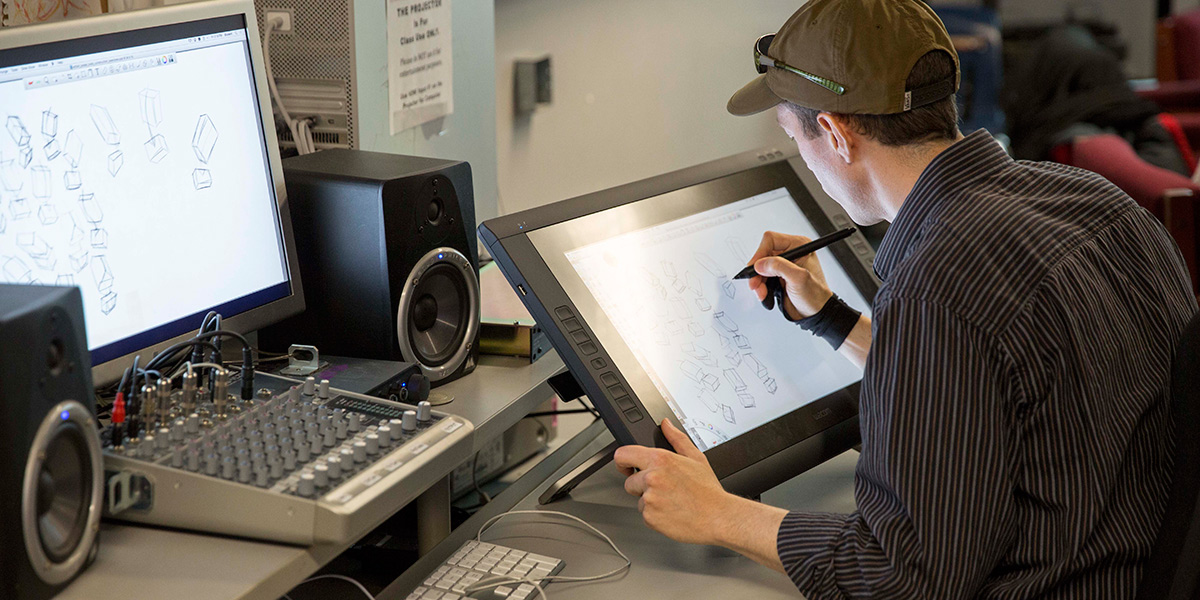 Photo of student drawing sketches in animation lab