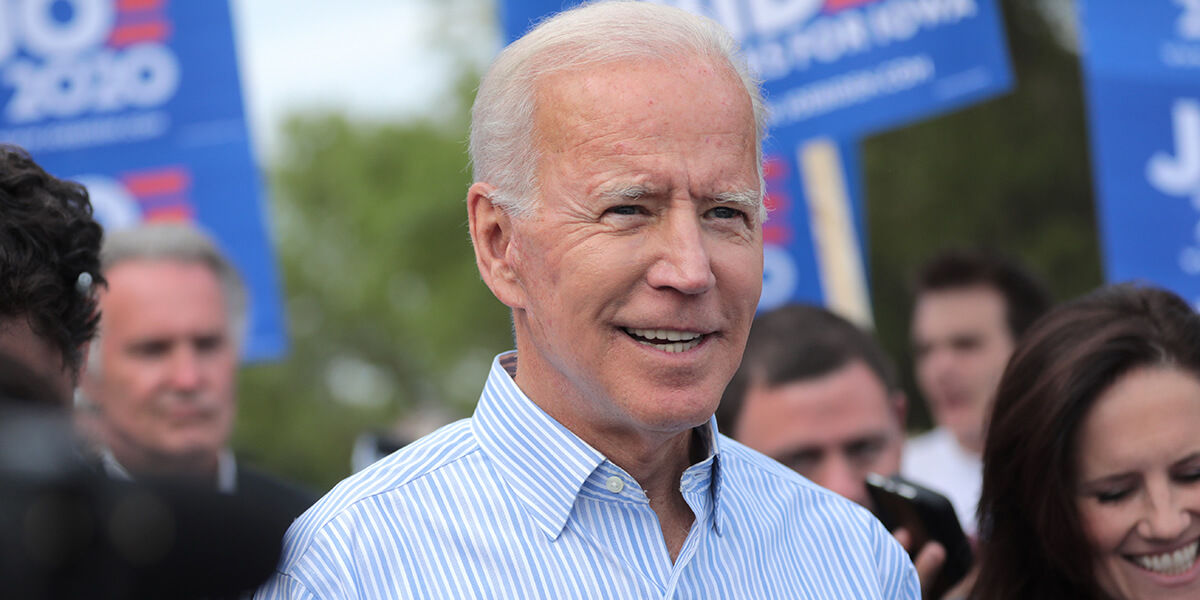 Joe Biden smiling at an outdoor event for his 2020 presidential campaign