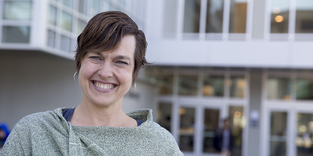 Photo of Jen Cross in front of J. Paul Leonard Library