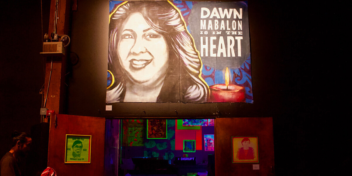 Photo of altar installation honoring Dawn Mabalon including mural stating "Dawn Mabalon is in the Heart"