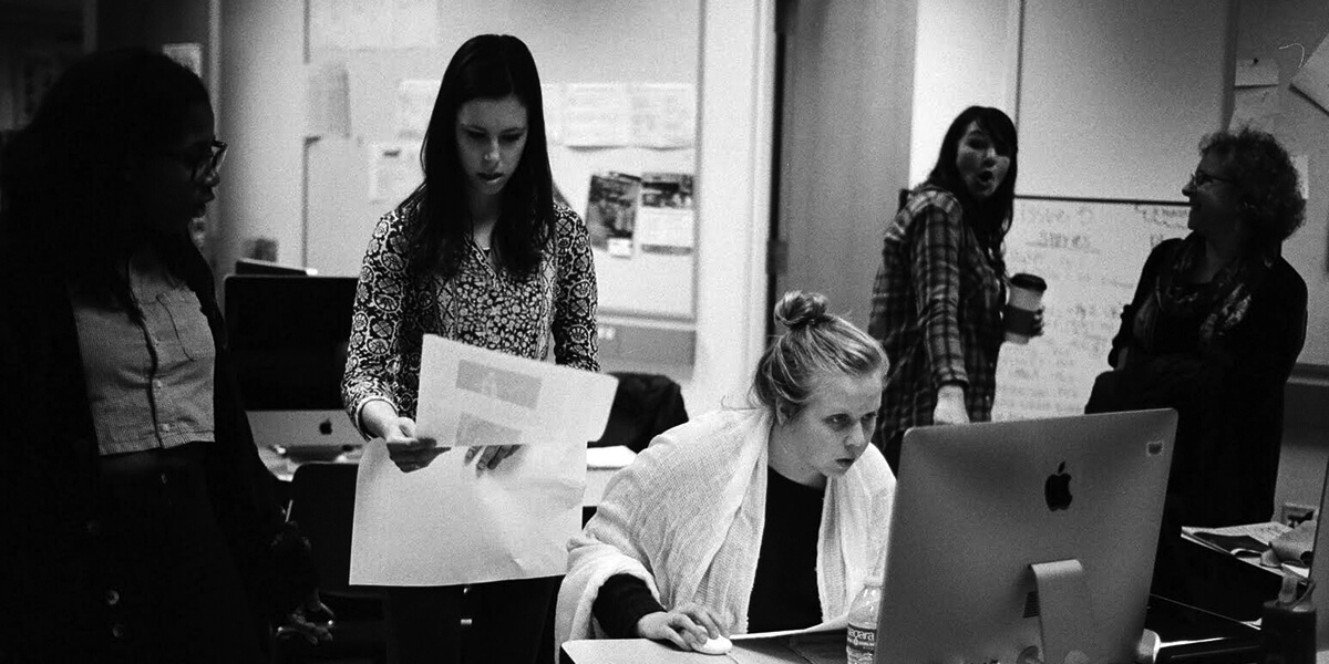 Black and white photo of students and adviser in Golden Gate Xpress newsroom