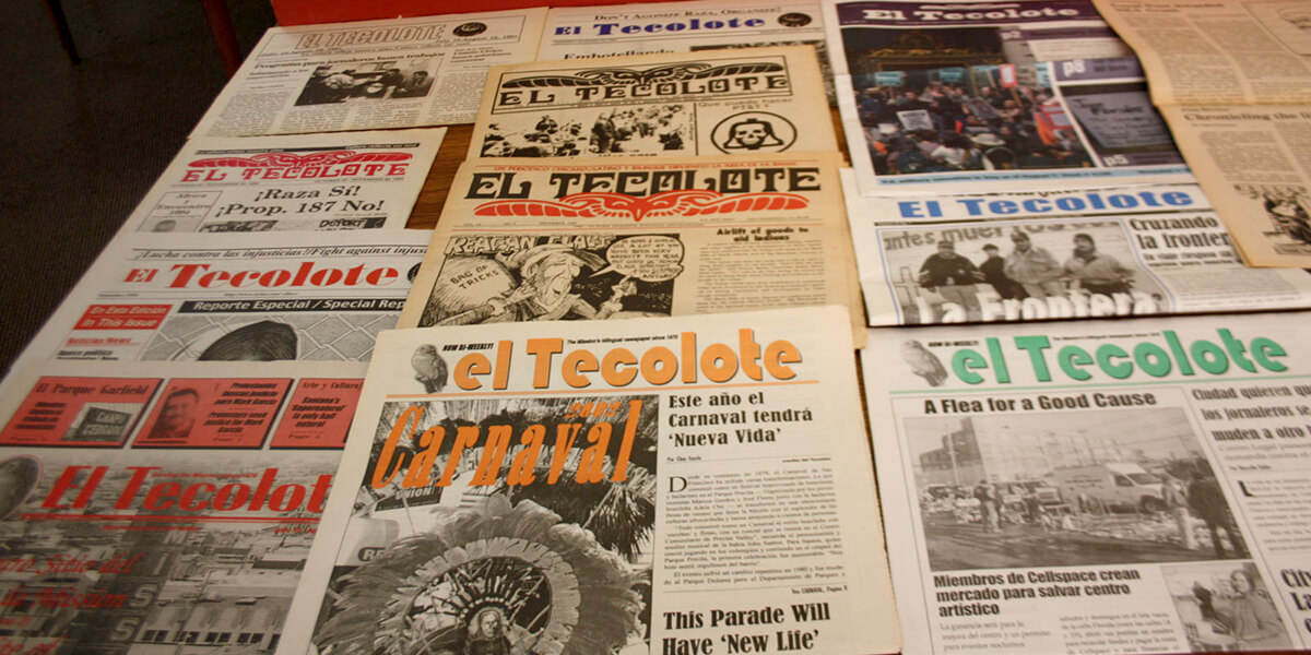 Photo of editions of El Tecolote newspaper laid out on a table