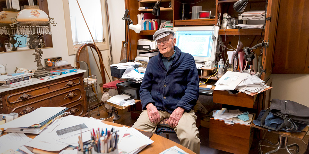 Photo of Gene Geisler sitting in his home office