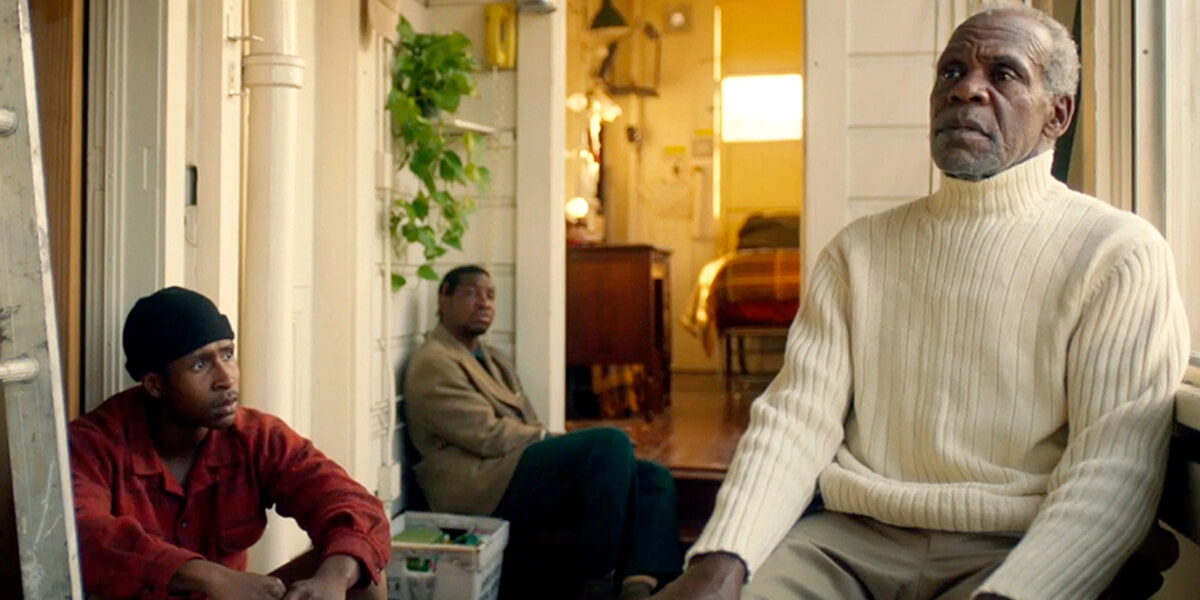 Photo of Jimmie Fails, Jonathan Majors and Danny Glover sitting in a house