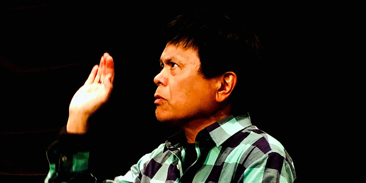 Photo of Emil Guillermo holding up his right hand