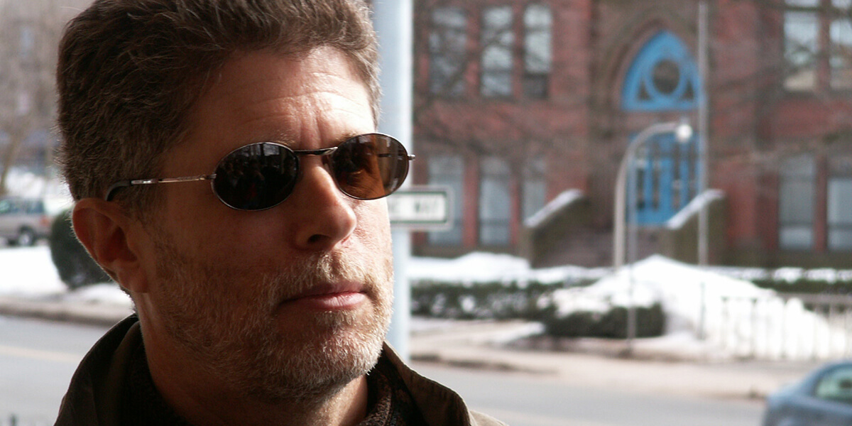 Photo of Jeff Jacoby wearing sunglasses outdoors on a snowy day