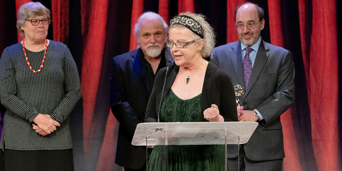 Photo of Nancy "Sami" Reist giving acceptance speech for BECA Department's Emmy Award