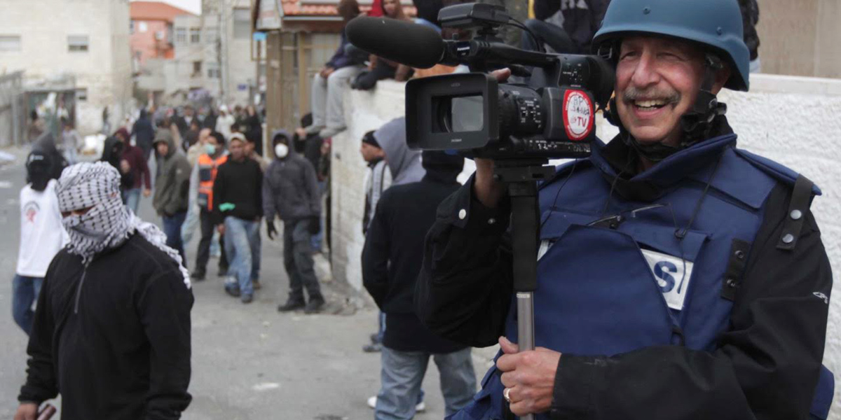 Photo of Professor Ken Kobre shooting footage in Israel for his 2013 documentary about Associated Press photographers