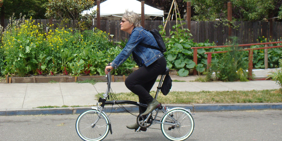 Photo of Catherine Kudlick riding her bicycle